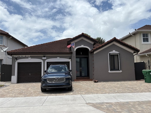 16419 SW 84th St, Miami, FL 33193 - mediterranean / spanish home with french doors, decorative driveway, an attached garage, and stucco siding