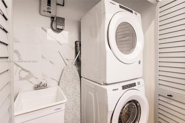3645 SW 3rd St, Miami, FL 33135 - laundry room with stacked washer / drying machine and water heater