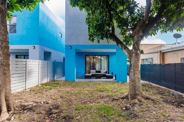 3645 SW 3rd St, Miami, FL 33135 - back of house featuring outdoor lounge area, stucco siding, a patio area, and a fenced backyard