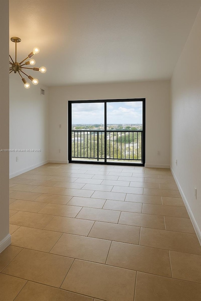 4242 NW 2nd St Unit 807, Miami, FL 33126 - empty room featuring light tile patterned floors, a chandelier, and baseboards
