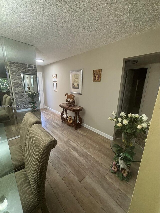2929 SE Ocean Blvd Unit 125-3, Stuart, FL 34996 - living room featuring wood-type flooring and a textured ceiling