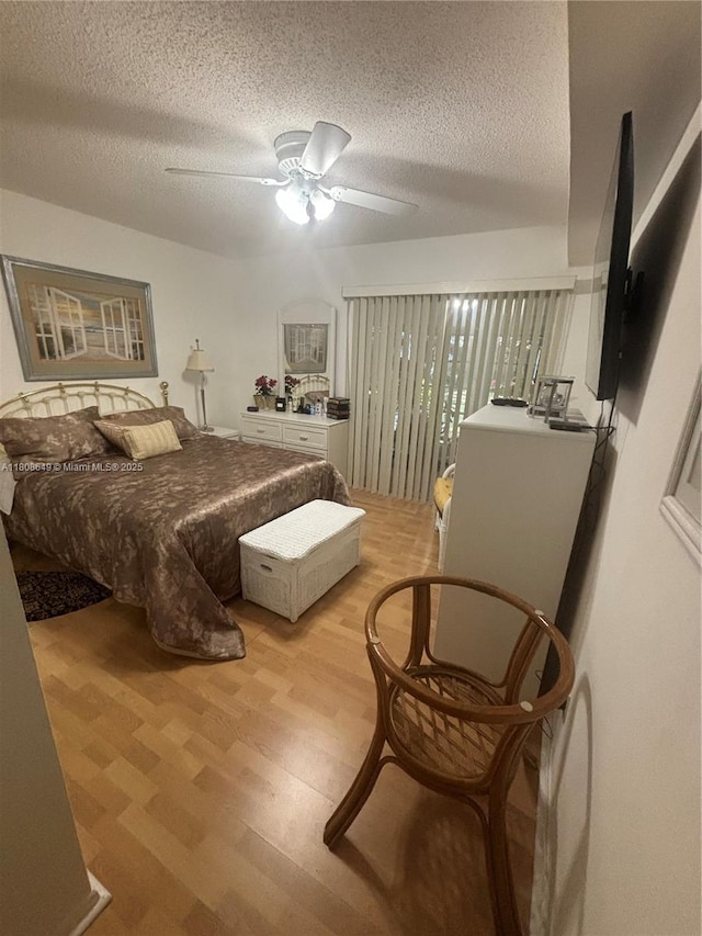 2929 SE Ocean Blvd Unit 125-3, Stuart, FL 34996 - bedroom featuring a textured ceiling, light wood-type flooring, and ceiling fan