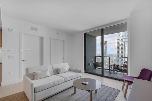 601 NE 6th St Unit 3709, Miami, FL 33132 - living area with expansive windows, light tile patterned floors, and baseboards