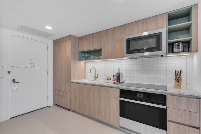 601 NE 6th St Unit 3709, Miami, FL 33132 - kitchen with wall oven, stainless steel microwave, open shelves, a sink, and modern cabinets