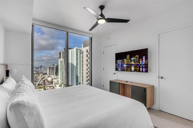 601 NE 6th St Unit 3709, Miami, FL 33132 - bedroom featuring light tile patterned floors, a wall of windows, and ceiling fan