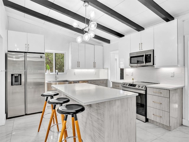 2454 W Nassau Ln, Fort Lauderdale, FL 33312 - kitchen with stainless steel appliances, light marble finish floors, decorative backsplash, light countertops, and white cabinetry