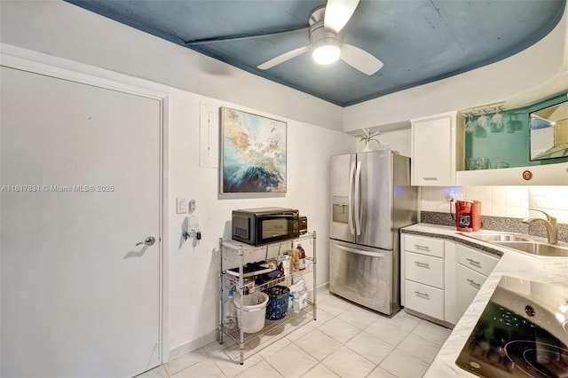 3233 NE 34th St Unit 611, Fort Lauderdale, FL 33308 - kitchen with black appliances, a sink, white cabinetry, and ceiling fan