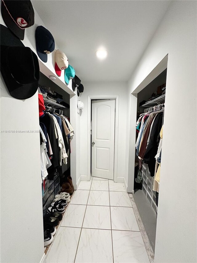 5975 SW 137th Ave Unit 902, Miami, FL 33183 - walk in closet with marble look tile flooring