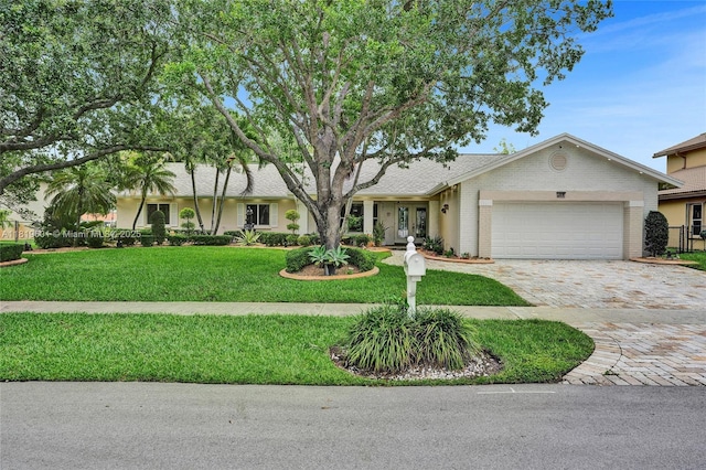 411 NW 201st Ave, Pembroke Pines, FL 33029 - single story home featuring an attached garage, decorative driveway, a front yard, french doors, and brick siding