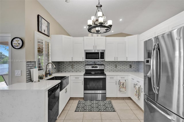 411 NW 201st Ave, Pembroke Pines, FL 33029 - kitchen featuring appliances with stainless steel finishes, lofted ceiling, a chandelier, tasteful backsplash, and white cabinets