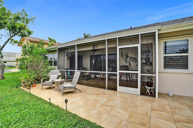 411 NW 201st Ave, Pembroke Pines, FL 33029 - back of property with a sunroom, stucco siding, a yard, and a patio
