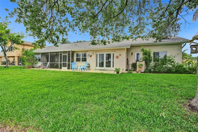411 NW 201st Ave, Pembroke Pines, FL 33029 - back of property with a sunroom, a yard, stucco siding, french doors, and a patio