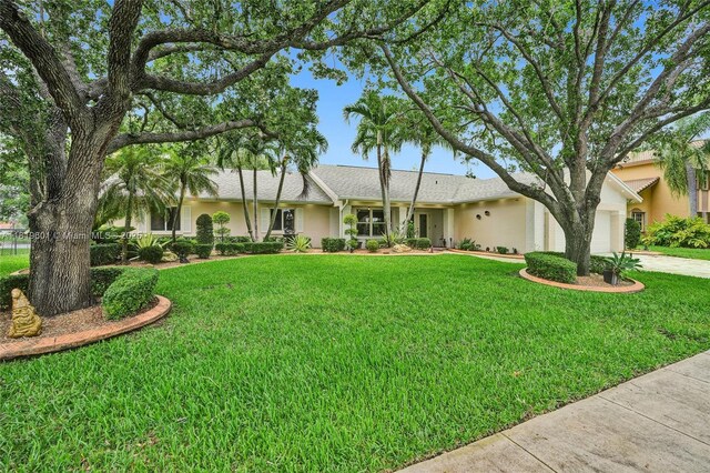 411 NW 201st Ave, Pembroke Pines, FL 33029 - ranch-style house with stucco siding, a garage, a front lawn, and driveway