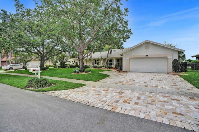 411 NW 201st Ave, Pembroke Pines, FL 33029 - ranch-style home with decorative driveway, an attached garage, a front lawn, and brick siding