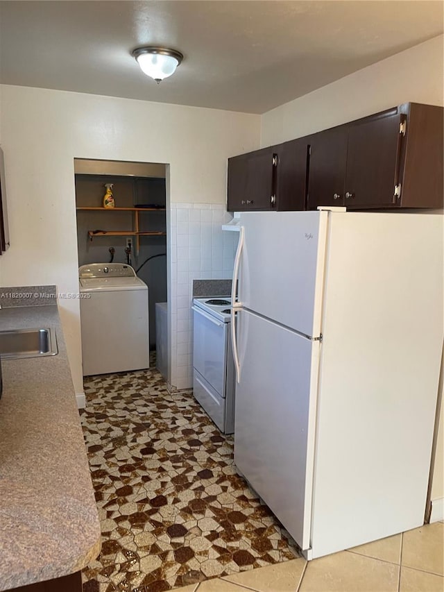 357 SW 1st Ter, Deerfield Beach, FL 33441 - kitchen with washer / dryer, white appliances, a sink, and tile patterned floors