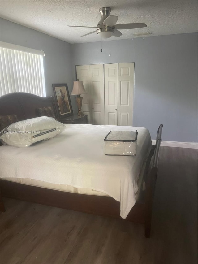 357 SW 1st Ter, Deerfield Beach, FL 33441 - bedroom with wood finished floors, a closet, a textured ceiling, ceiling fan, and baseboards