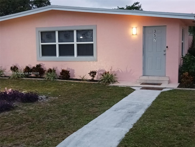 357 SW 1st Ter, Deerfield Beach, FL 33441 - view of front of property with a front lawn and stucco siding