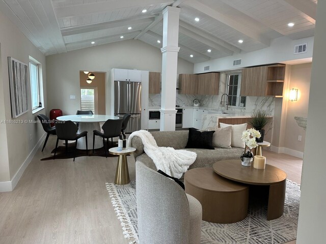 659 NE 73rd St, Miami, FL 33138 - living area with ornate columns, light wood-style floors, and recessed lighting