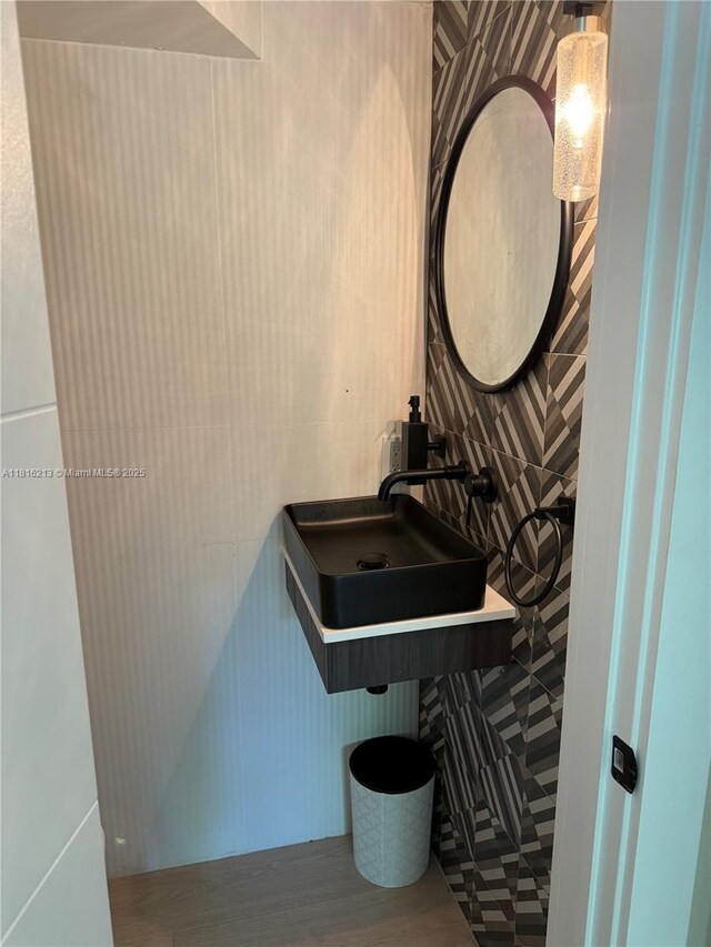 659 NE 73rd St, Miami, FL 33138 - half bathroom with wood finished floors and a sink
