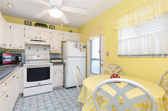 1001 NE 14th Ave Unit 107, Hallandale Beach, FL 33009 - kitchen featuring white appliances, under cabinet range hood, decorative backsplash, a ceiling fan, and light flooring