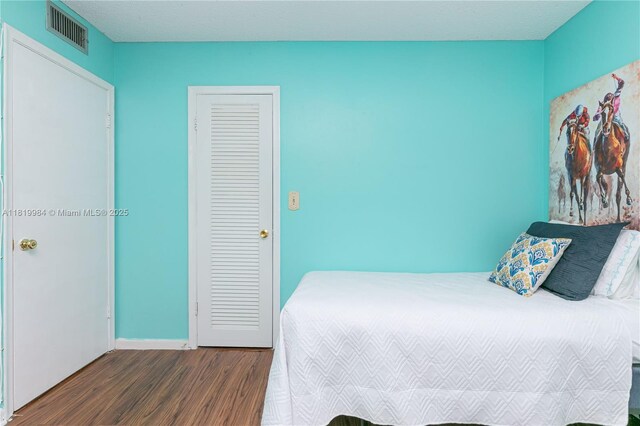 1001 NE 14th Ave Unit 107, Hallandale Beach, FL 33009 - bedroom featuring wood finished floors and baseboards