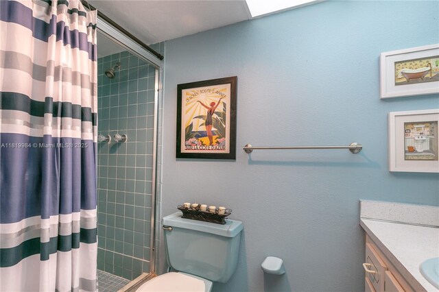1001 NE 14th Ave Unit 107, Hallandale Beach, FL 33009 - bathroom featuring a tile shower, toilet, and vanity