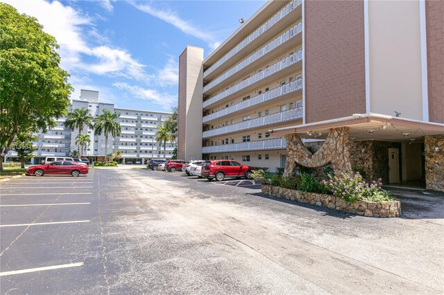 1001 NE 14th Ave Unit 107, Hallandale Beach, FL 33009 - view of building exterior with uncovered parking