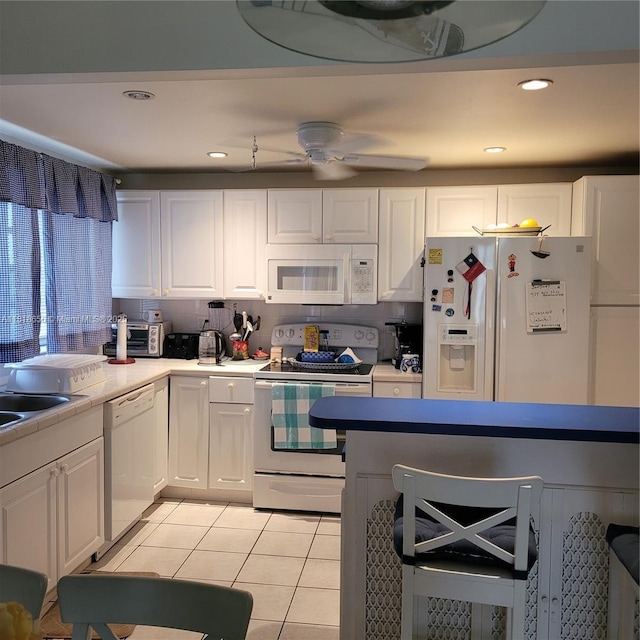 1801 S Ocean Dr Unit 739, Hallandale Beach, FL 33009 - kitchen with white appliances, light tile patterned floors, white cabinets, ceiling fan, and recessed lighting