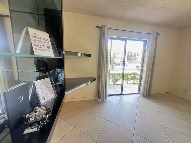 523 Trace Cir Unit 105, Deerfield Beach, FL 33441 - doorway with a textured ceiling and tile patterned floors