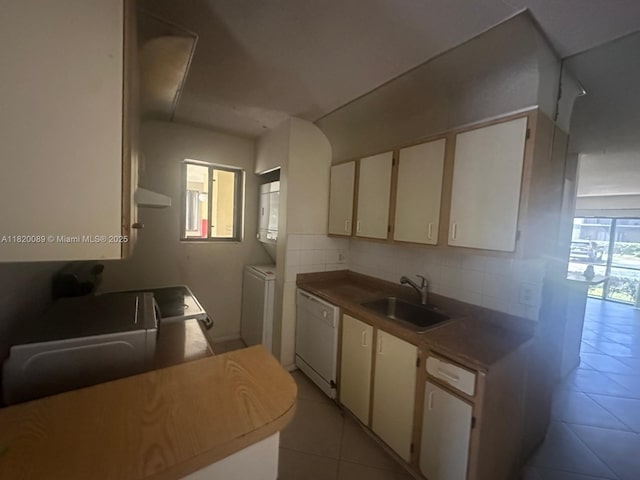 523 Trace Cir Unit 105, Deerfield Beach, FL 33441 - kitchen with dishwasher, a sink, light tile patterned floors, white cabinets, and extractor fan