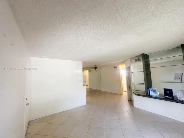 523 Trace Cir Unit 105, Deerfield Beach, FL 33441 - unfurnished room with a textured ceiling, ceiling fan, and light tile patterned flooring