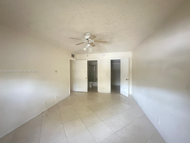523 Trace Cir Unit 105, Deerfield Beach, FL 33441 - spare room featuring a ceiling fan, light tile patterned floors, and a textured ceiling