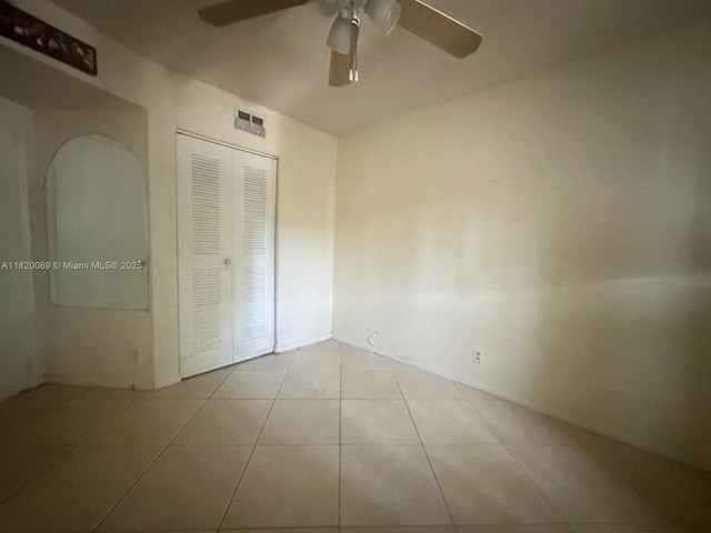 523 Trace Cir Unit 105, Deerfield Beach, FL 33441 - unfurnished bedroom with a closet, tile patterned flooring, and ceiling fan