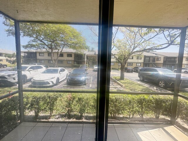 523 Trace Cir Unit 105, Deerfield Beach, FL 33441 - sunroom / solarium featuring a residential view