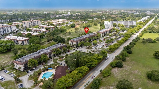 5550 NW 44th St Unit 205B, Lauderhill, FL 33319 - view of property location with nearby urban area, apartment complex / building, a tree filled landscape, and a pool