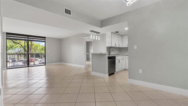 5550 NW 44th St Unit 205B, Lauderhill, FL 33319 - kitchen with dishwasher, white cabinetry, baseboards, light countertops, and light tile patterned flooring