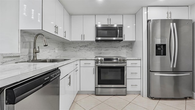5550 NW 44th St Unit 205B, Lauderhill, FL 33319 - kitchen featuring appliances with stainless steel finishes, a sink, white cabinets, and light tile patterned flooring