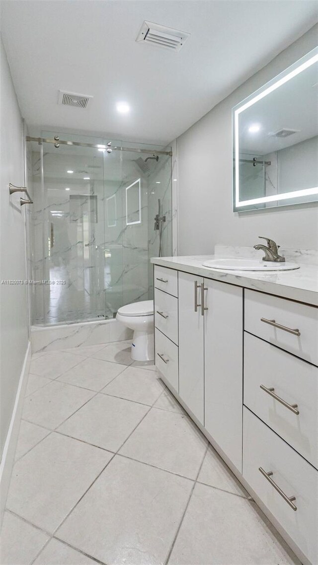 5550 NW 44th St Unit 205B, Lauderhill, FL 33319 - full bathroom with vanity, a marble finish shower, toilet, tile patterned floors, and baseboards