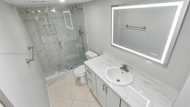 5550 NW 44th St Unit 205B, Lauderhill, FL 33319 - bathroom featuring toilet, a marble finish shower, vanity, and tile patterned flooring