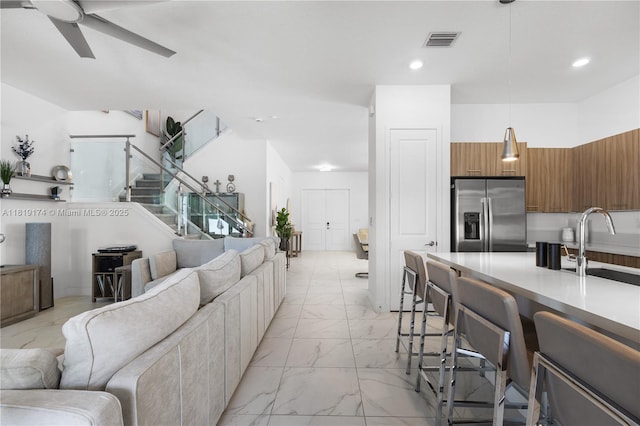 17540 SW 46th St, Miramar, FL 33029 - living room featuring light marble finish flooring, ceiling fan, stairway, and recessed lighting