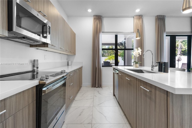 17540 SW 46th St, Miramar, FL 33029 - kitchen featuring range with electric stovetop, stainless steel microwave, modern cabinets, a sink, and light marble finish flooring