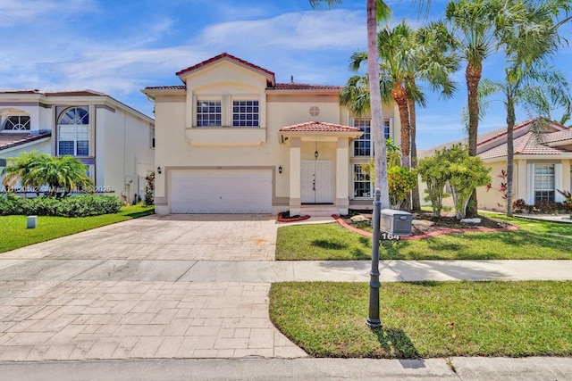 164 Granada Ave, Weston, FL 33326 - mediterranean / spanish home with a tiled roof, decorative driveway, stucco siding, an attached garage, and a front yard