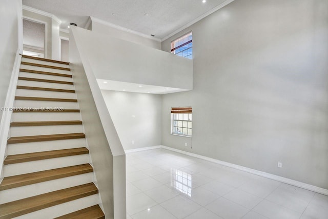 164 Granada Ave, Weston, FL 33326 - staircase with crown molding, plenty of natural light, tile patterned flooring, and a towering ceiling