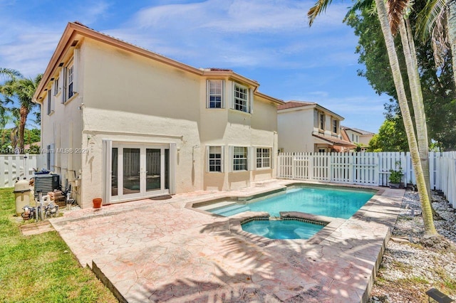 164 Granada Ave, Weston, FL 33326 - rear view of property with stucco siding, a patio area, a fenced backyard, a pool with connected hot tub, and french doors