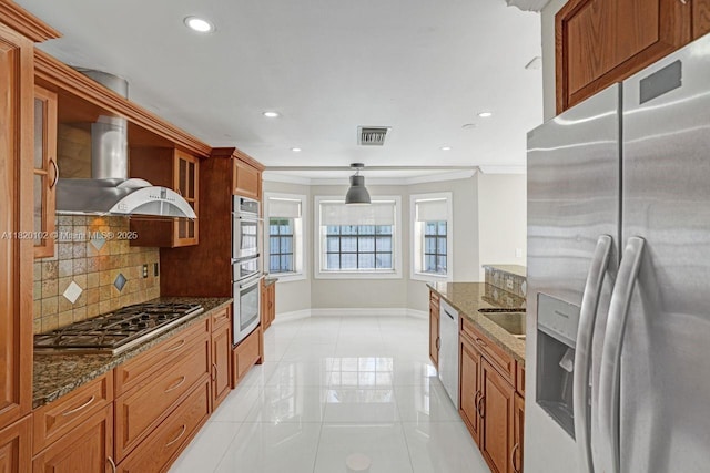 164 Granada Ave, Weston, FL 33326 - kitchen featuring appliances with stainless steel finishes, wall chimney exhaust hood, decorative backsplash, crown molding, and dark stone countertops