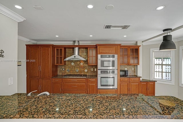 164 Granada Ave, Weston, FL 33326 - kitchen featuring gas cooktop, wall chimney range hood, double oven, brown cabinetry, and crown molding