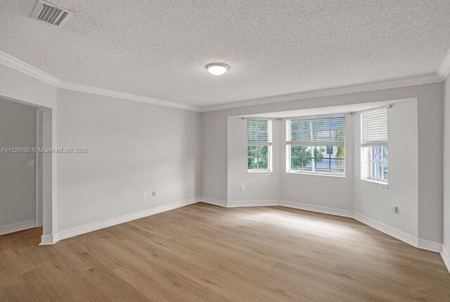 164 Granada Ave, Weston, FL 33326 - unfurnished room with light wood finished floors, crown molding, and a textured ceiling