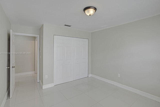 164 Granada Ave, Weston, FL 33326 - unfurnished bedroom featuring a closet and light tile patterned floors