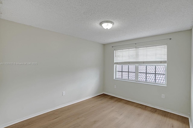 164 Granada Ave, Weston, FL 33326 - spare room with wood finished floors and a textured ceiling