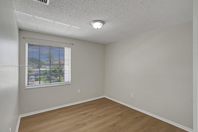 164 Granada Ave, Weston, FL 33326 - empty room with wood finished floors and a textured ceiling